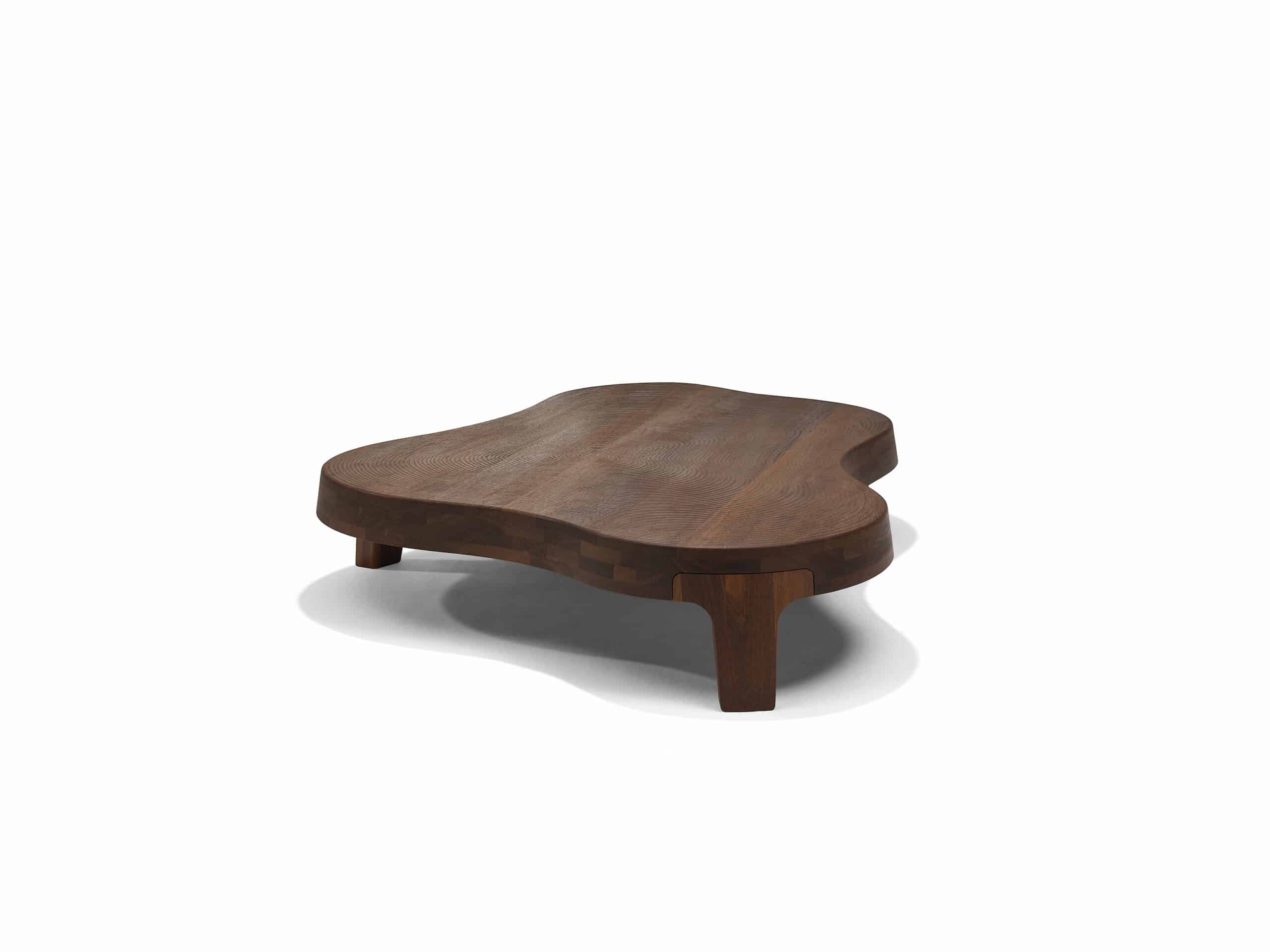 Linteloo Isola coffee table made of reddish brown sucupira wood, organically shaped like an island on three legs. The top of the coffee table is CNC milled to seem like the ridges left of the beach after the water draws back.