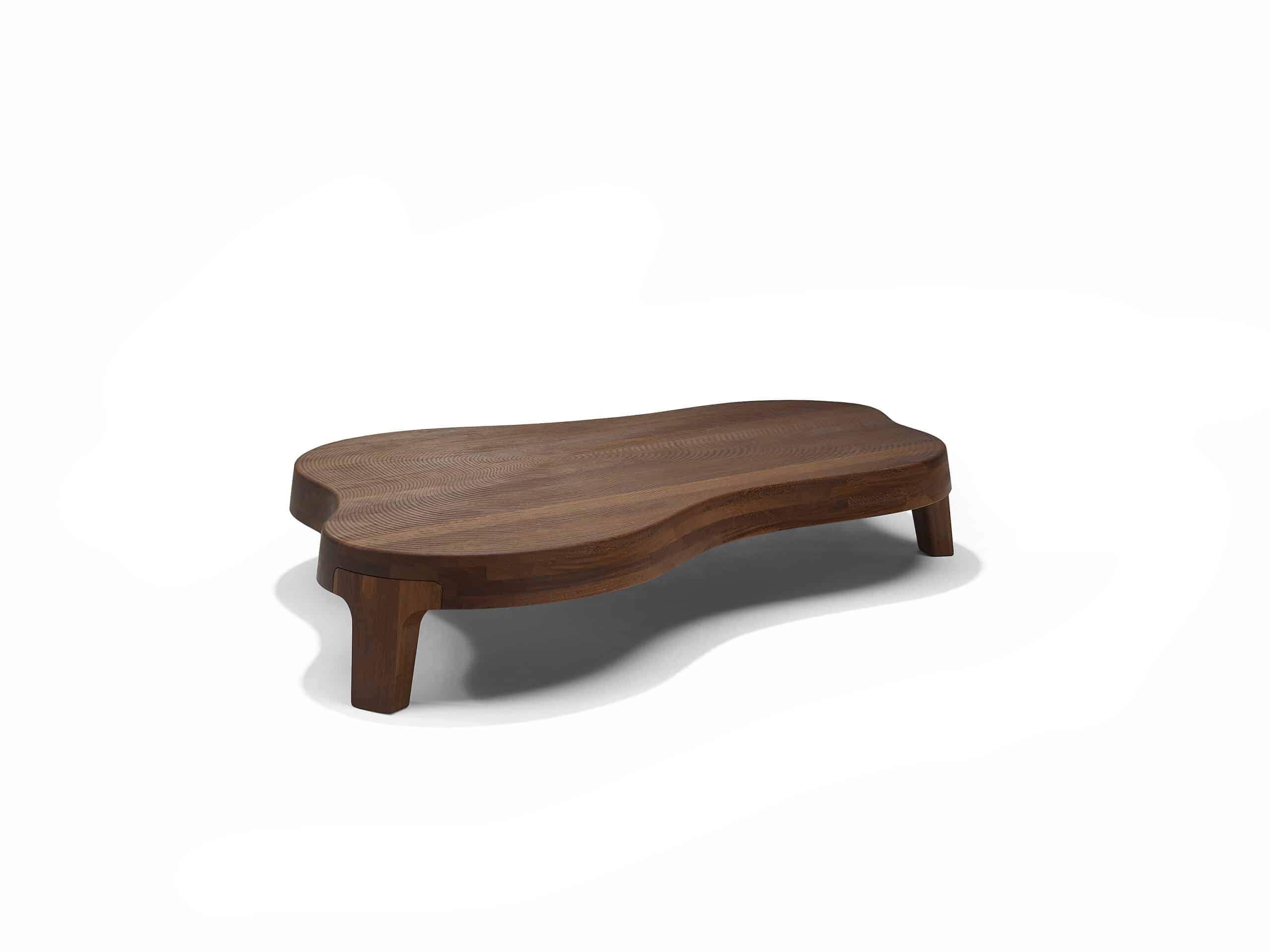 Linteloo Isola coffee table made of reddish brown sucupira wood, organically shaped like an island on three legs. The top of the coffee table is CNC milled to seem like the ridges left of the beach after the water draws back.