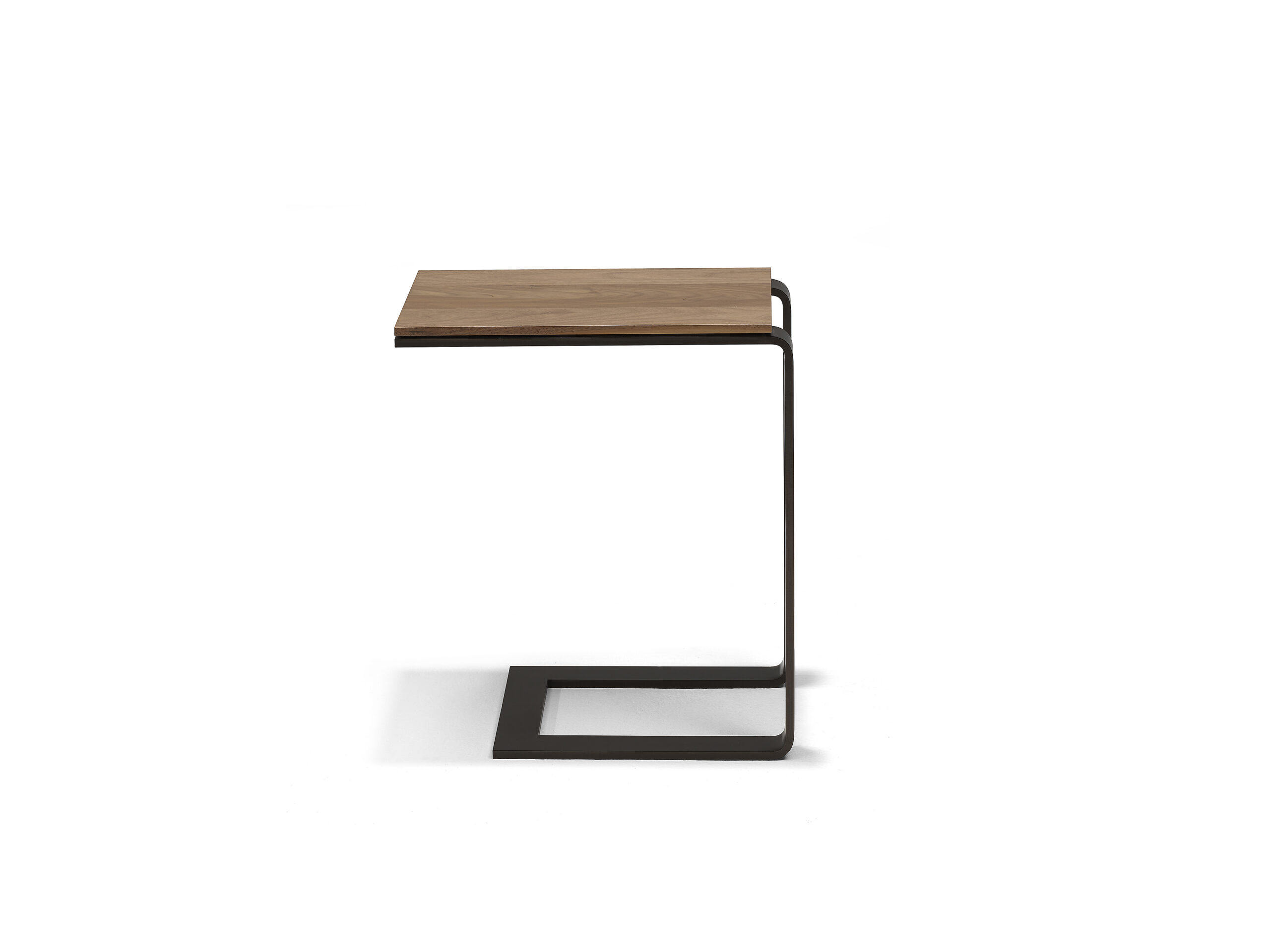 The Linteloo Malibu side table, made of metal U-shaped frame in a bronze or gunmetal finish and a walnut table top. Meant as a table that can slide under your sofa so you have a small table over the seat cushion.