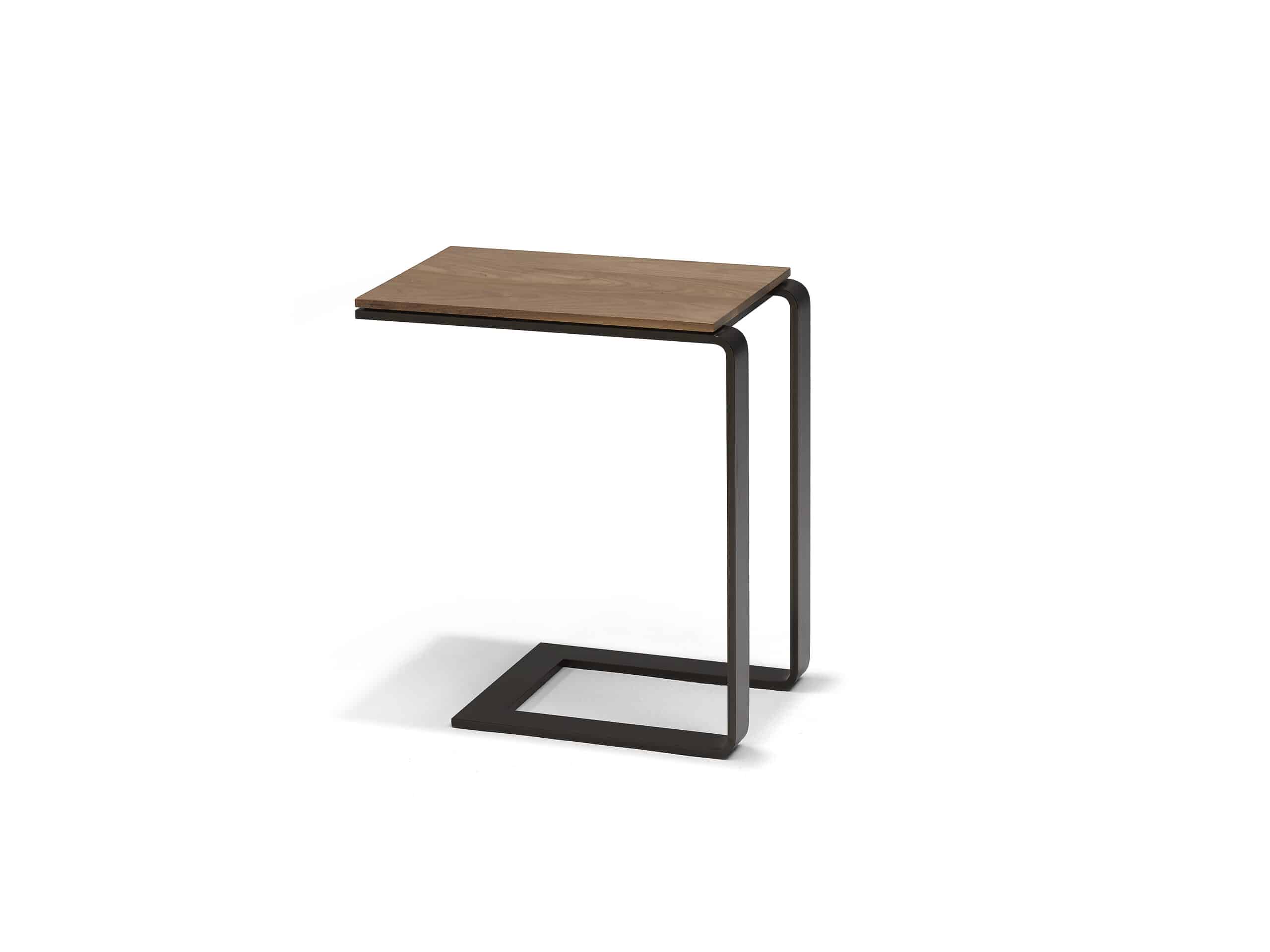 The Linteloo Malibu side table, made of metal U-shaped frame in a bronze or gunmetal finish and a walnut table top. Meant as a table that can slide under your sofa so you have a small table over the seat cushion.