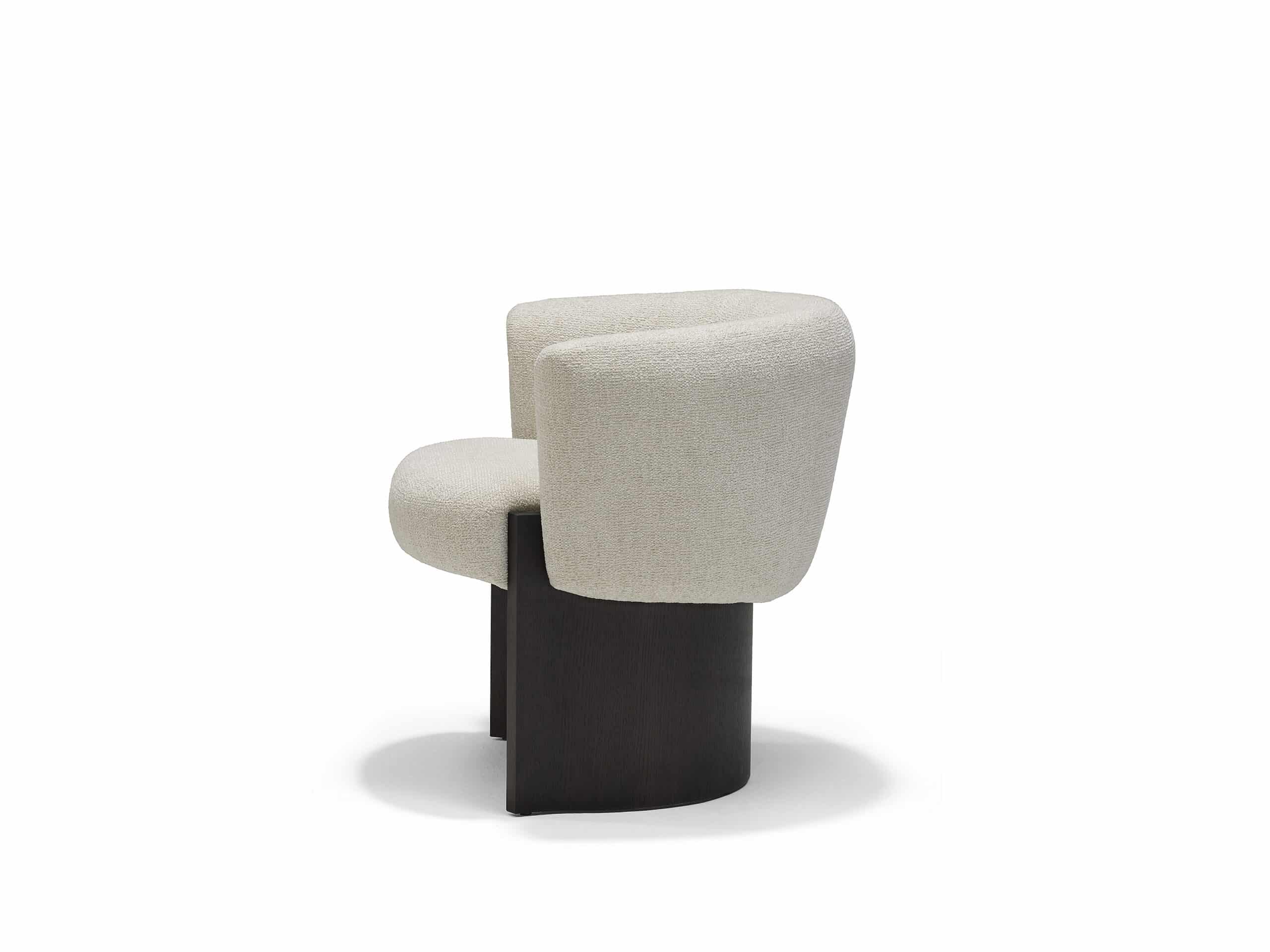 The Linteloo Claude dining chair, with a C-shaped oak veneer base and an upholstered seat and back.