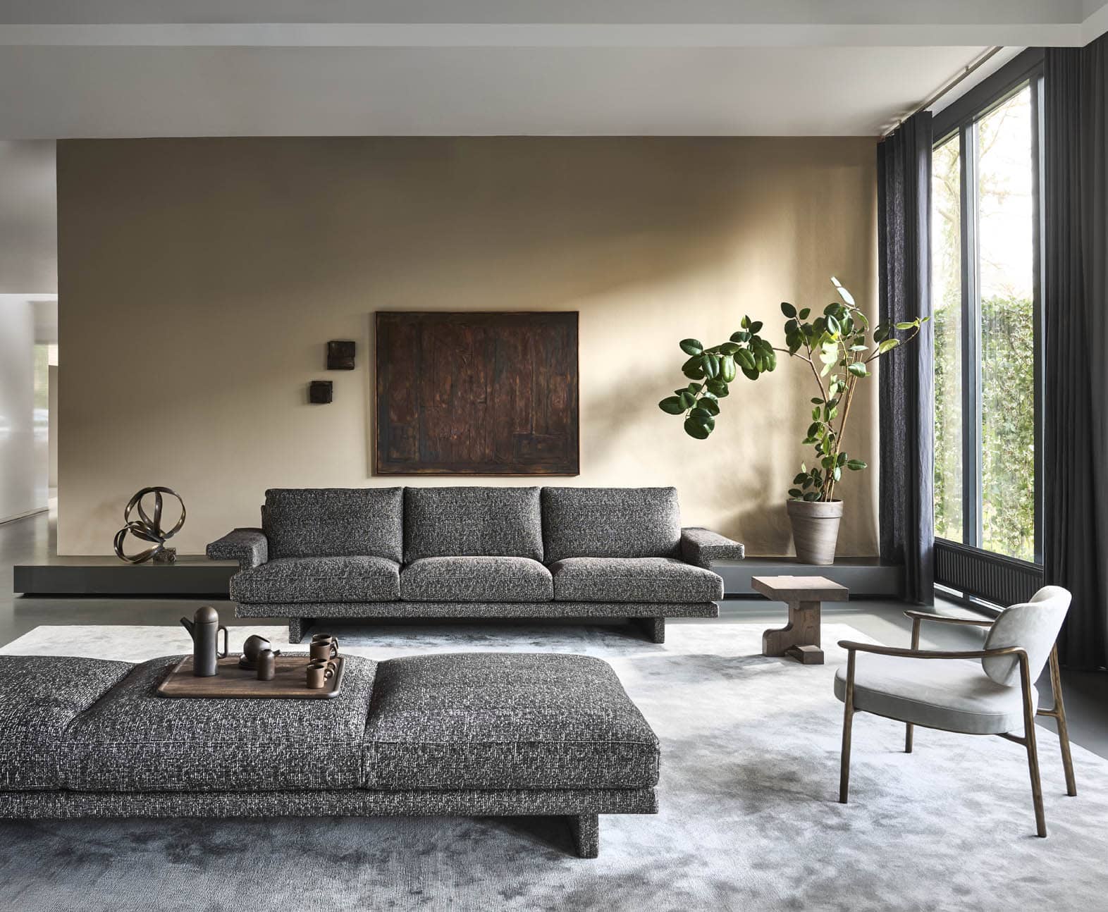 Linteloo Frank sofa, fully upholstered, even the legs, and with practical large armrests for your laptop, book or drink. Combined with a large day bed in the same fabric, a big rug, Flux side table and the bronze Gentle chair.