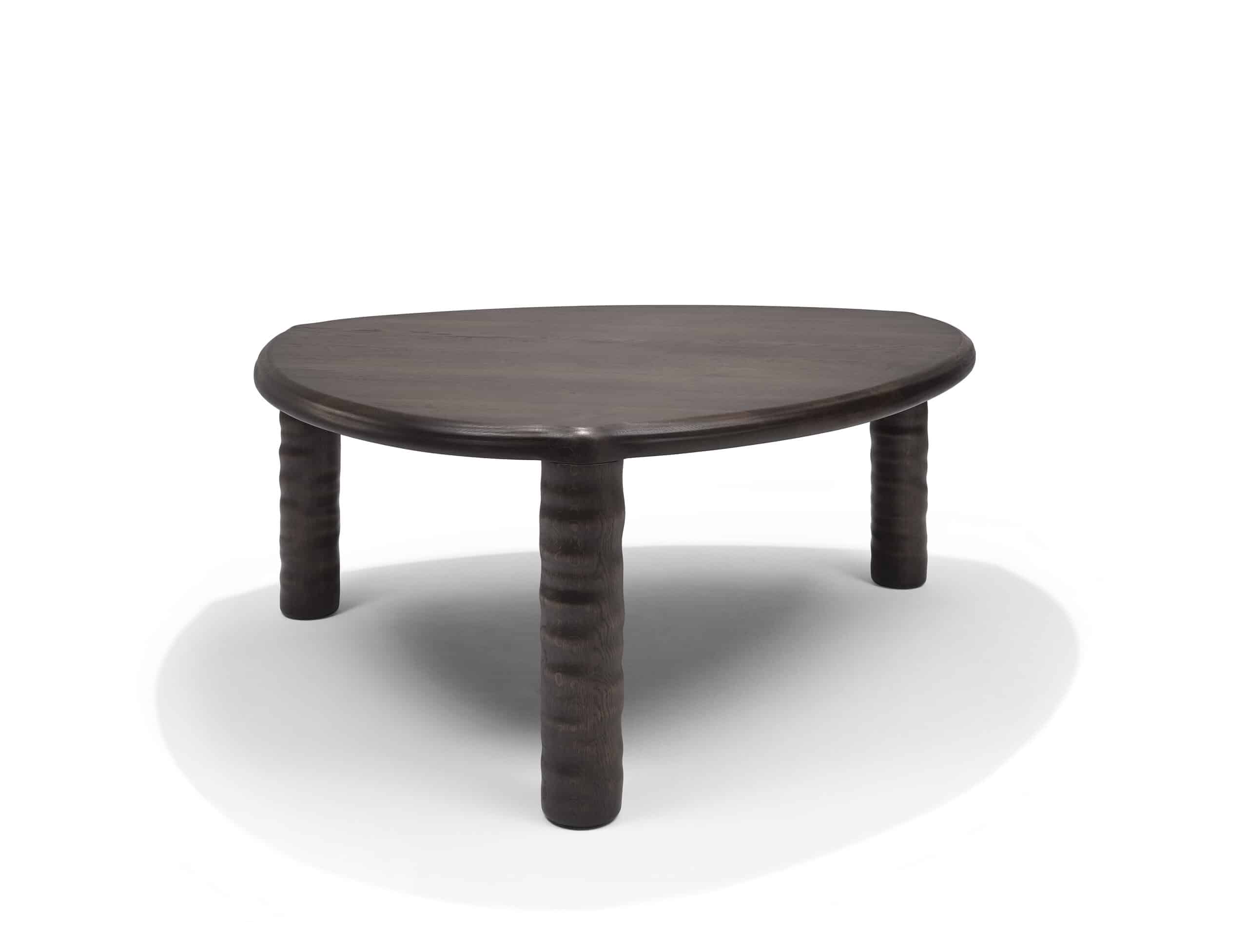 Front view of Linteloo Tembo table, made of solid oak wood in a dark brown finish. The table has three legs and a rounded triangle shape, with thick elephant trunk like legs.