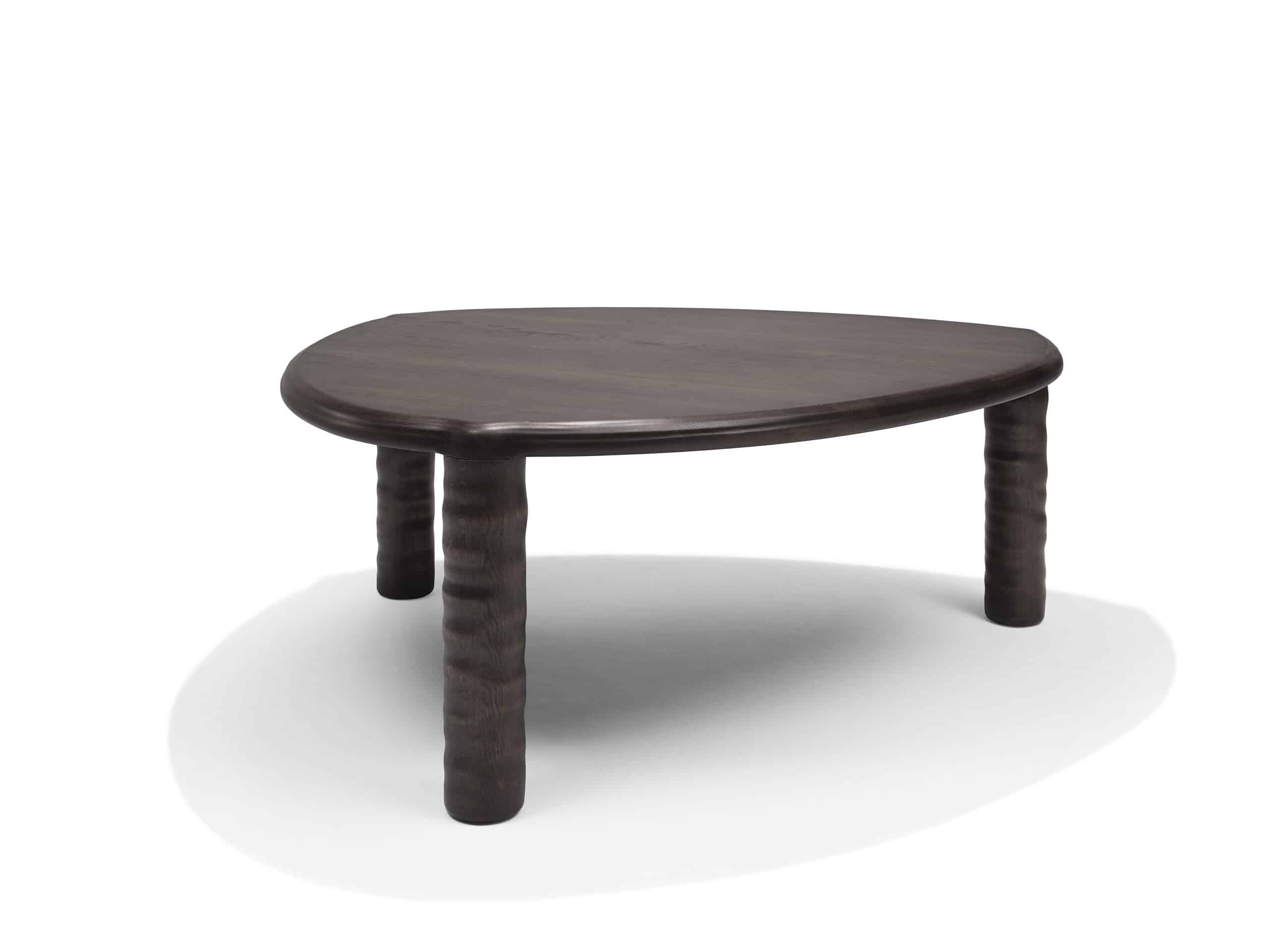 Front view of Linteloo Tembo table, made of solid oak wood in a dark brown finish. The table has three legs and a rounded triangle shape, with thick elephant trunk like legs.