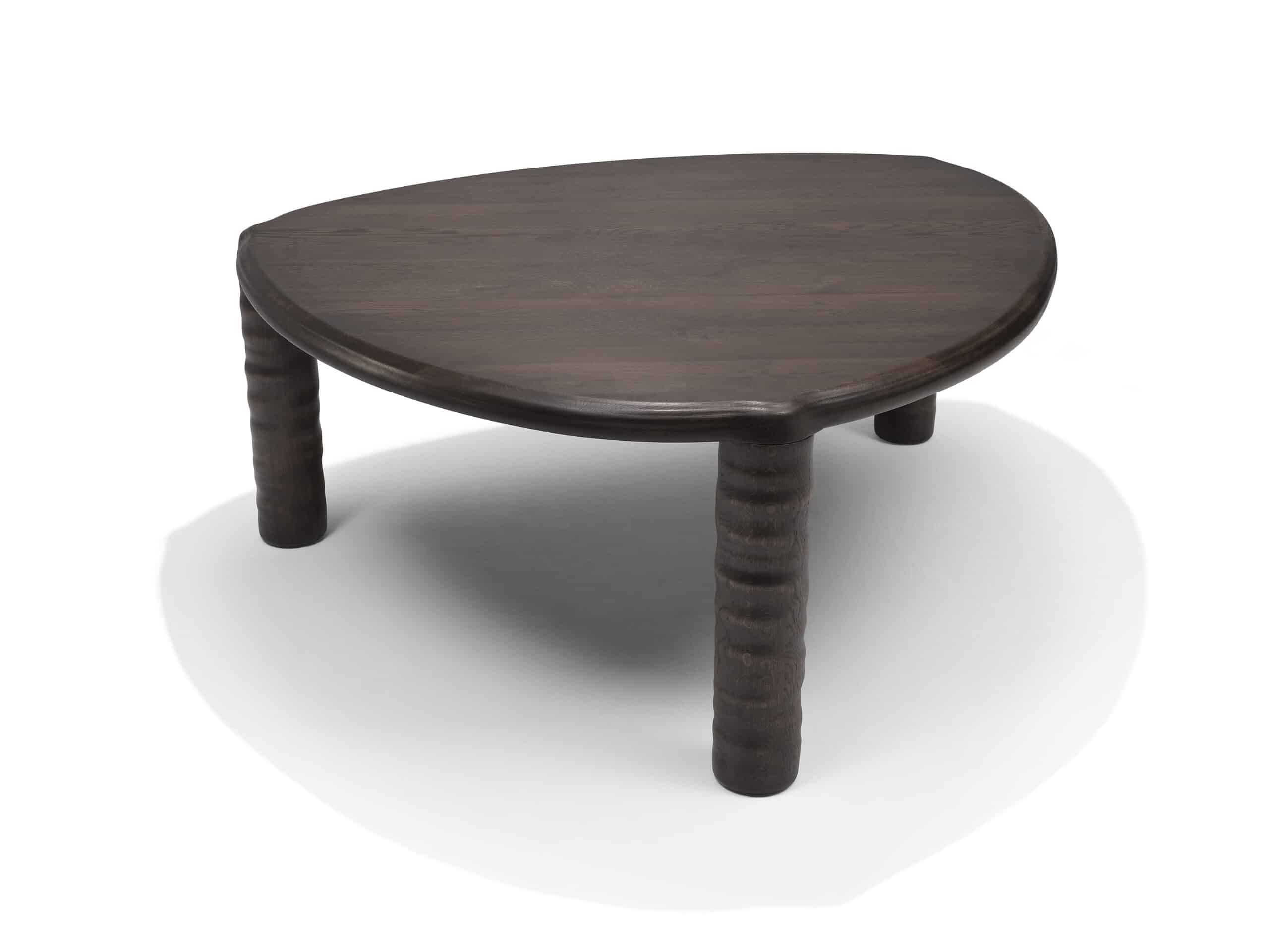 Front view of Linteloo Tembo table, made of solid oak wood in a dark brown finish. The table has three legs and a rounded triangle shape, with thick elephant trunk like legs.
